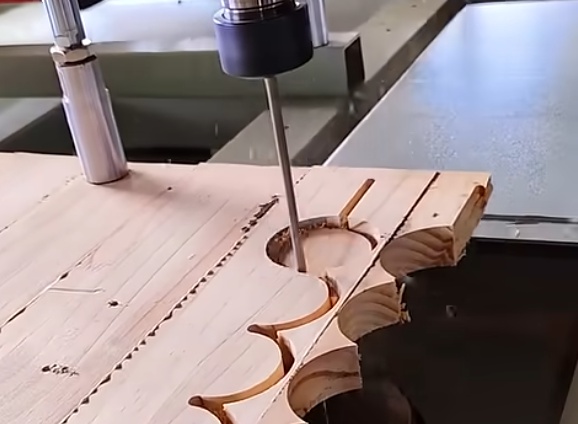 Operator programming a CNC wood cutting machine