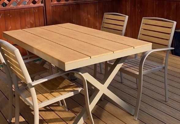 Outdoor wooden furniture treated for weather resistance